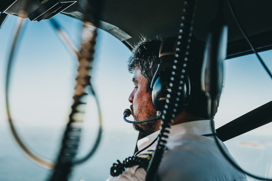 Helicopter pilot navigating over a city &mdash; a typical view for commercial tour and corporate helicopter pilots in 2026.