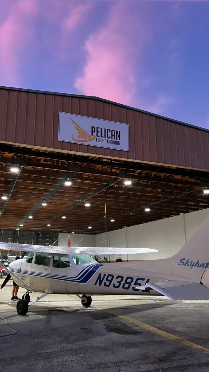 Pelican Flight Training Cessna 172 Skyhawk in front of the hangar at sunset