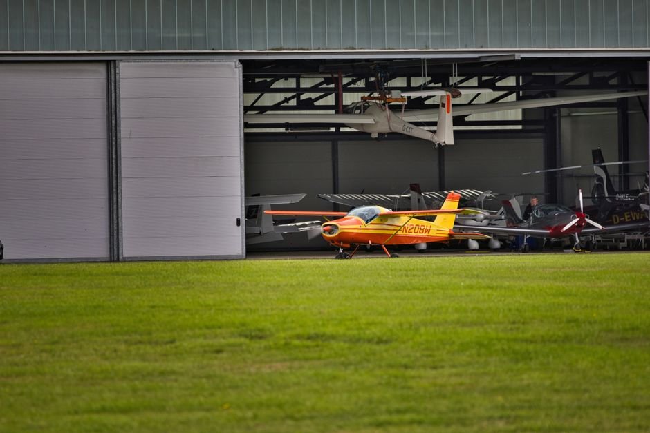 Line of single engine training aircraft parked on a Part 141 flight school ramp.