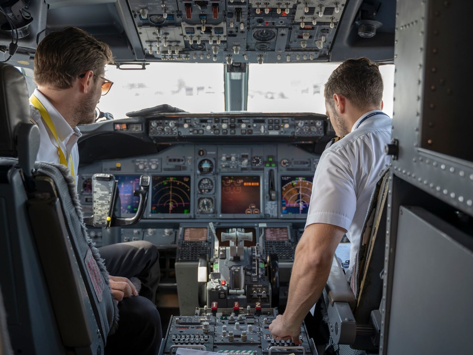 Airline pilot at the controls of a passenger jet during flight