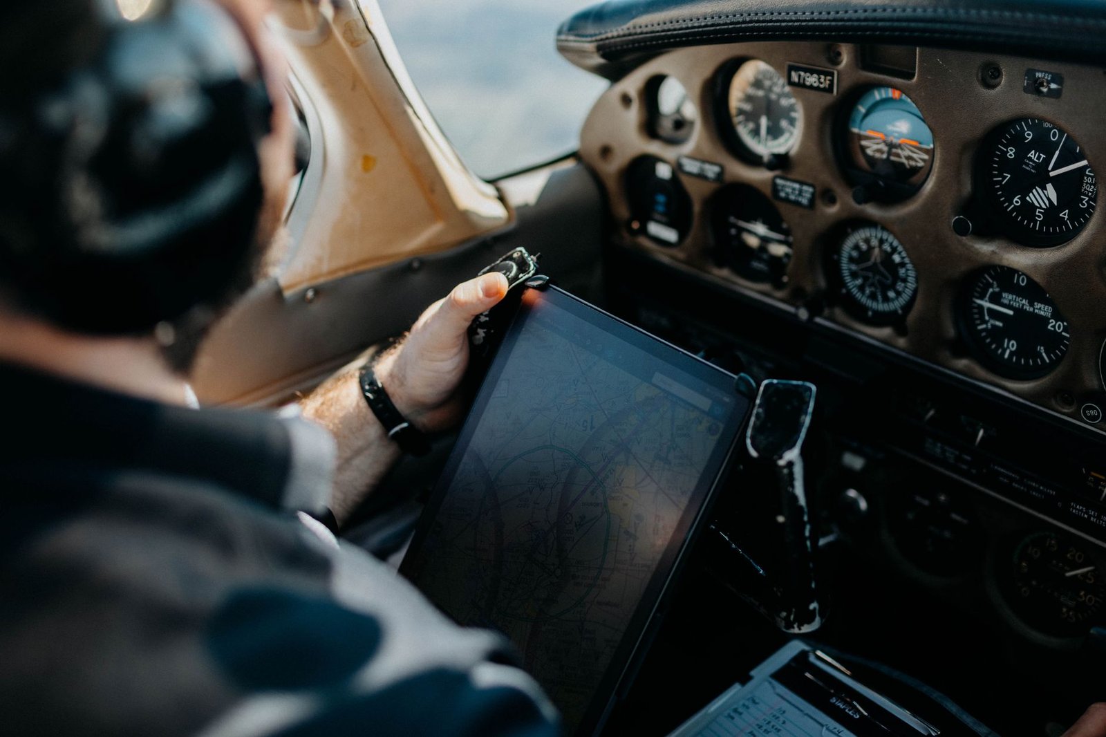 Pilot planning a flight with aviation charts