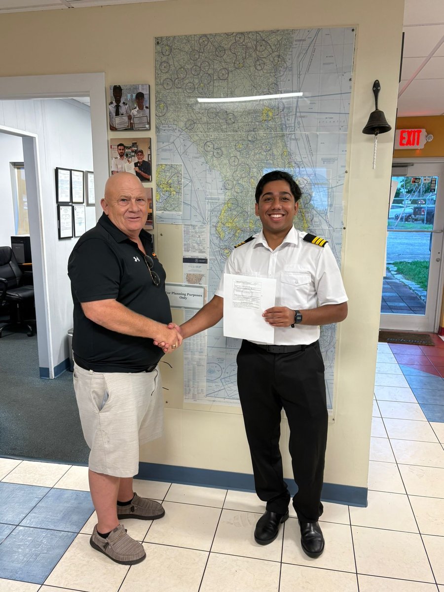 Pelican student Kallichanda with the examiner after passing his CFI checkride