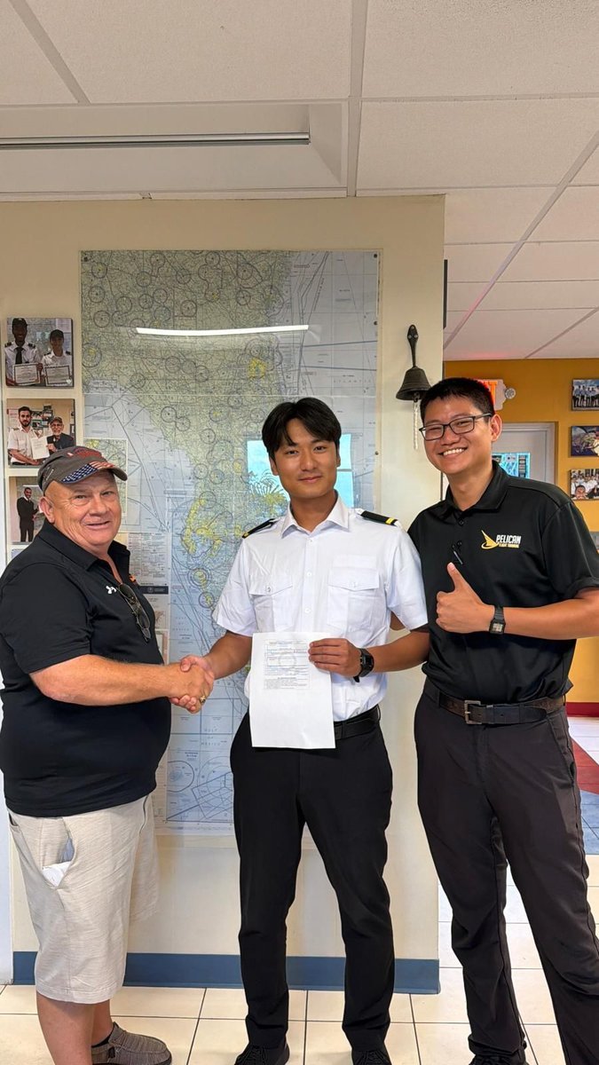 Pelican student shaking hands with the examiner after passing the Private Pilot checkride