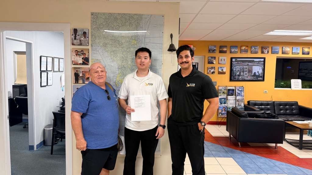 Pelican student Zhang with his instructor and the examiner after passing the Commercial checkride