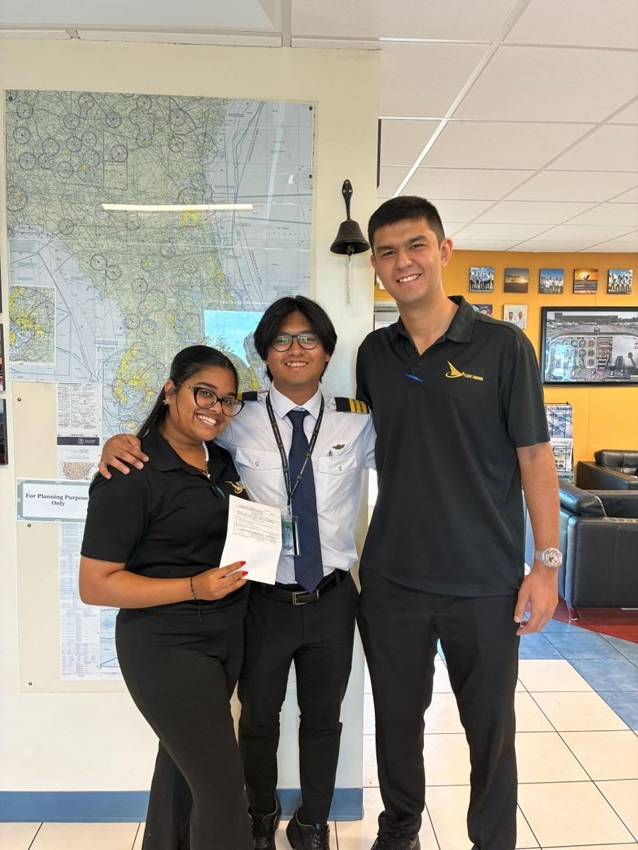 Pelican students celebrating a Multi-Engine add-on checkride pass at North Perry Airport