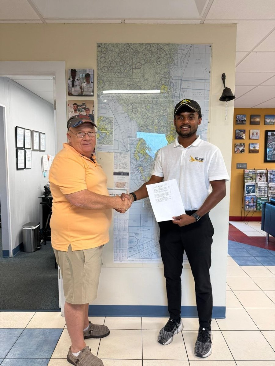 Pelican student Vismay with the examiner after passing his CFII checkride