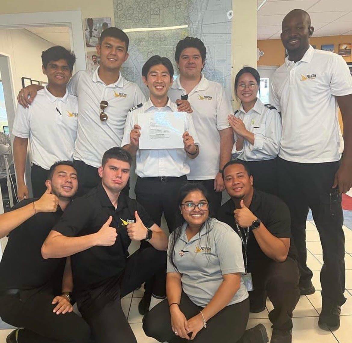 Group of pilots celebrating success at Pelican Flight School.