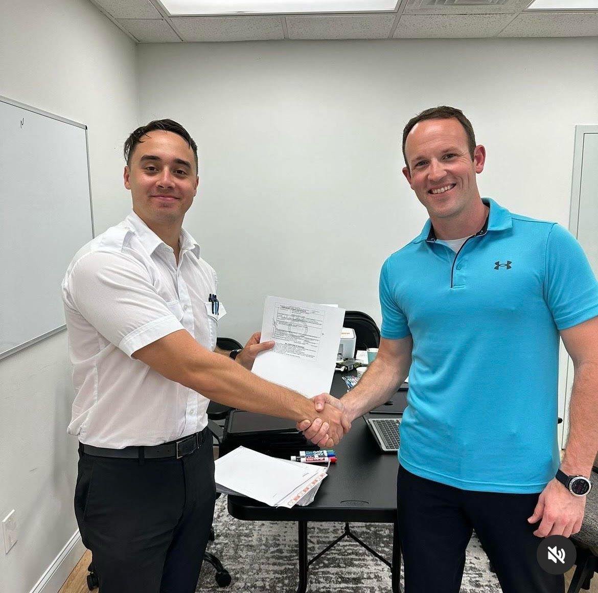 Pelican Flight School graduate receiving certification from instructor.